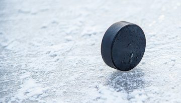 Hockey Puck on Ice Photo
