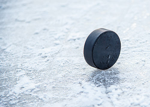Hockey Puck on Ice Photo